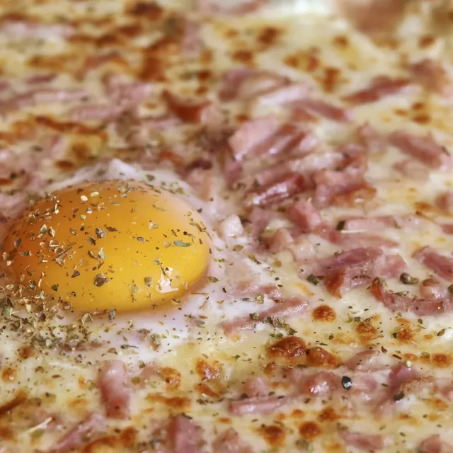 Pizza de un cliente recién salida del horno de leña